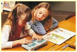 two girls reading, one with notetaker, and one with print book