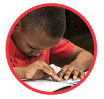 kid reading braille - link to What is Braille
